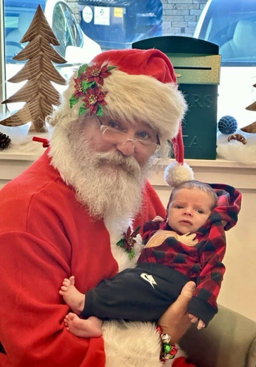 Santa gently holding a baby