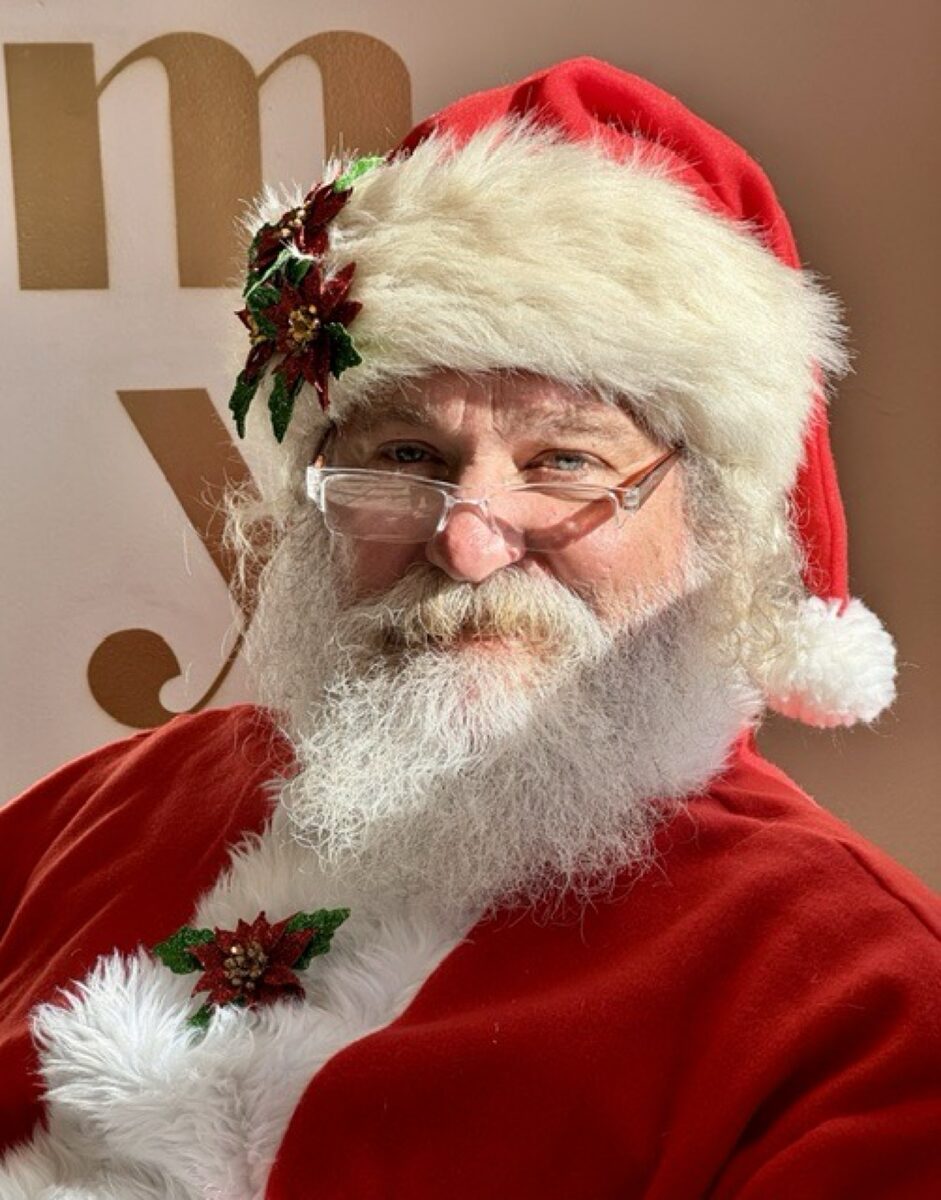 Close portrait of Santa with white beard and red hat